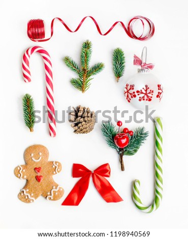 Flat lay Christmas composition with fir tree branches, gingerbread Christmas Cookie  and holiday ornament on white background. Top view.
