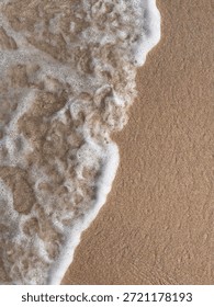 Flat Lay Close Up Of Ocean Wave Foam Meeting Wet Beach Sand Texture Background