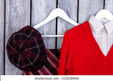 Flat Lay Close Up Women's Winter Outfit. Grey Desk Surface Background.