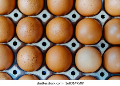 Flat Lay Close-up View Of Raw Chicken Eggs In Egg Paper Box.Overhead View Of Brown Chicken Eggs In An Open Egg Carton.Fresh Chicken Eggs Background. Top View Natural Organic Egg. Healthy Real Food.