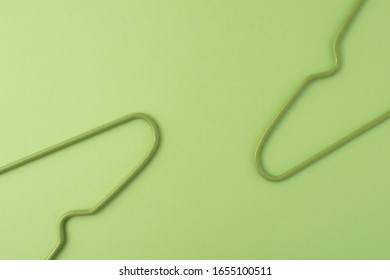 Flat lay with cloth hangers at green background. Shopping concept. - Shutterstock ID 1655100511