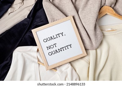 Flat Lay Of Clothes And Hangers; Assortment Of Women's Clothing. Second Hand Sustainable Shopping; Capsule Minimal Wardrobe; Slow Fashion Idea; Quality Not Quantity Concept