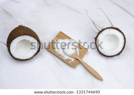 flat lay coconut and cocnut flakes  on a  marble table