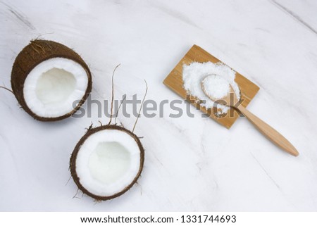 flat lay coconut and cocnut flakes  on a  marble table