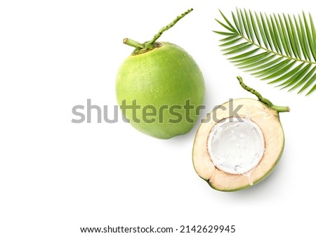 Flat lay of Coconut juice splash in half fruit isolated on white background.