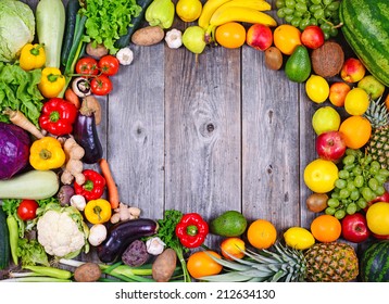 Flat lay - Collection of fresh Fruit and vegetables on wooden table in form of frame - High quality studio shot