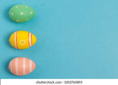 Flat Lay Of Colorful Easter Eggs With Different Shades And Textures On Light Bluebackground. Empty Space For Texts.