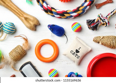 Flat lay composition with accessories for dog and cat on wooden background. Pet care - Powered by Shutterstock