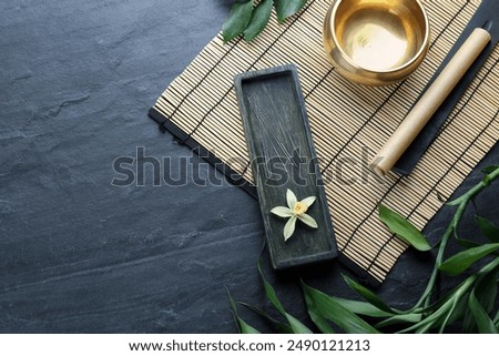 Flat lay composition with acupuncture needles on black table. Space for text