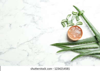 Flat lay composition with aloe vera leaves on marble background. Space for text