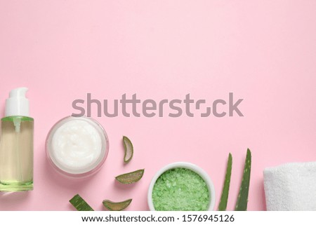 Flat lay composition with aloe vera and cosmetic products on pink background. Space for text