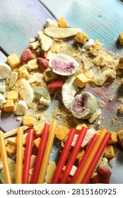 Flat lay composition of assorted dried fruits, berries, and bright straws.