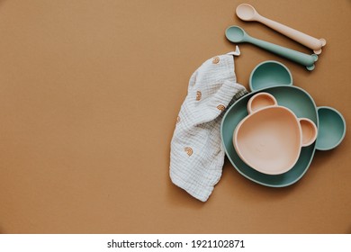 Flat lay composition with baby food accessory, plastic fruits, on light background. First baby food concept