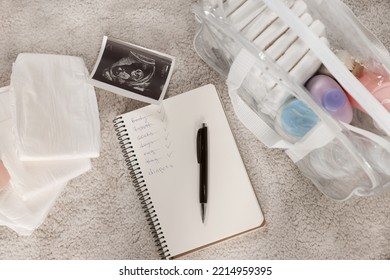 Flat Lay Composition With Baby Stuff, List And Ultrasound Scan On Beige Carpet