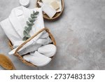 Flat lay composition with bathrobe and spa essentials on light grey background. Space for text