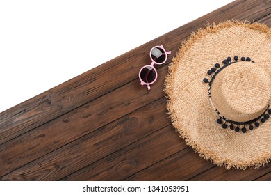 Flat lay composition with beach accessories on wooden background. Space for text