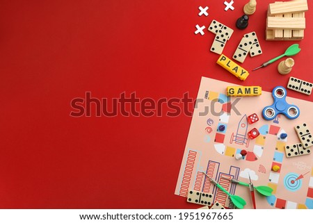 Flat lay composition of blocks with words Play Game on red background. Space for text