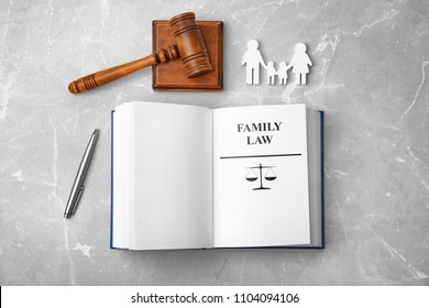 Flat lay composition with book and gavel on light background. Family law concept
