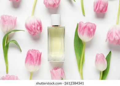 Flat lay composition with bottle of aromatic perfume and beautiful tulips on white background