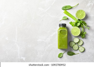 Flat lay composition with bottle of delicious detox juice and ingredients on light background
