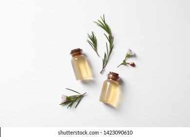 Flat Lay Composition With Bottles Of Natural Tea Tree Oil On White Background