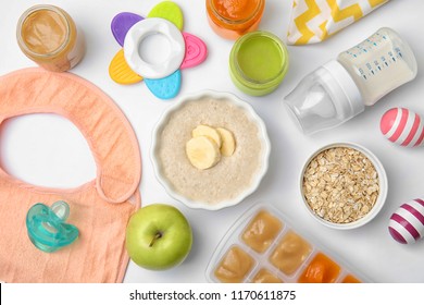 Flat Lay Composition With Bowl Of Healthy Baby Food On White Background