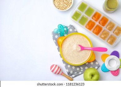 Flat Lay Composition With Bowl Of Healthy Baby Food And Space For Text On White Background