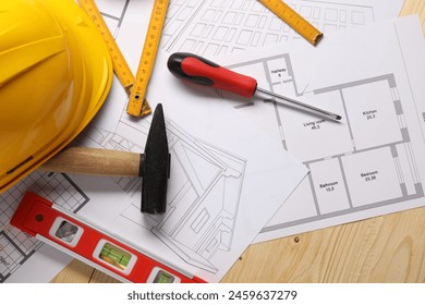 Flat lay composition with building level and other different construction tools on wooden background