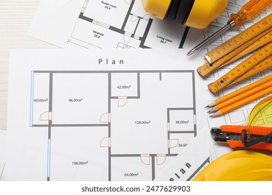 Flat lay composition with building level and other construction tools on white wooden table