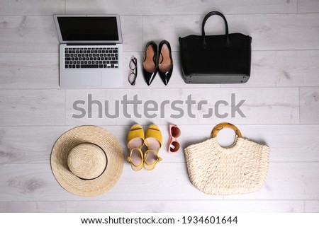 Flat lay composition of business items with vacation accessories on white wooden background. Life and work balance concept