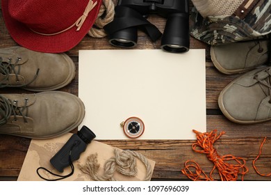 Flat Lay Composition With Camping Equipment On Wooden Background