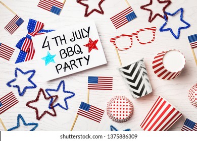 Flat lay composition with card and decorations on wooden table. USA Independence Day