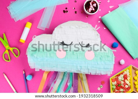 Flat lay composition with cardboard cloud on pink background. Pinata diy