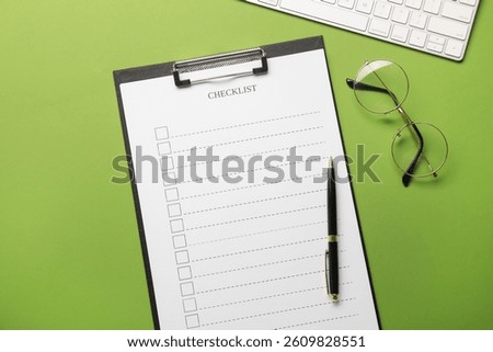 Flat lay composition with checklist on green background