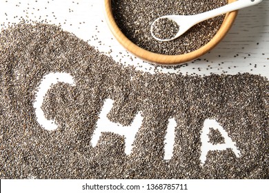 Flat lay composition with chia seeds on white wooden background