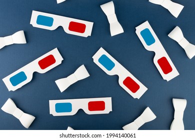 Flat Lay Composition With Classic 3D Movie Glasses And Paper Ribbons On Dark Blue Background. Conceptual Studio Shot.