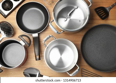 Flat lay composition with clean cookware on wooden background