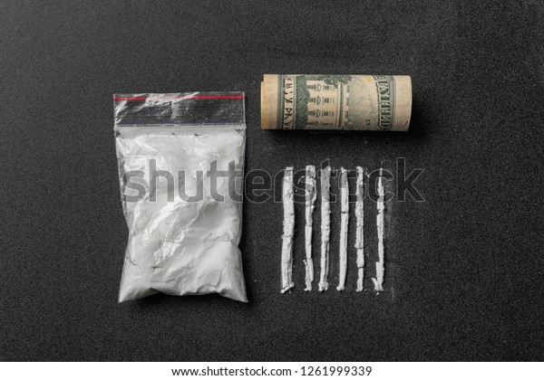 Flat lay composition with cocaine powder and\
money on black background