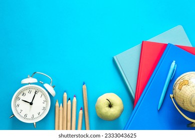 Flat lay composition with colorful educational supplies on blue background. - Powered by Shutterstock