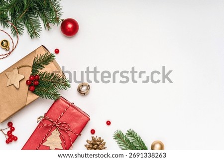 Flat lay composition with craft paper presents, eco wrapping and fir branches on white background. Copy space Christmas template for greetings and branding.