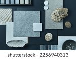 Flat lay composition of creative black architect moodboard with samples of building, textile and natural materials and personal accessories. Top view, black backgroung, template.