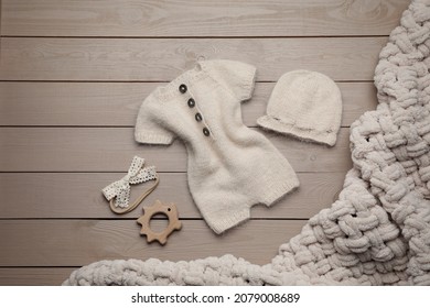 Flat Lay Composition With Cute Baby Knitwear For Photoshoot On Wooden Background