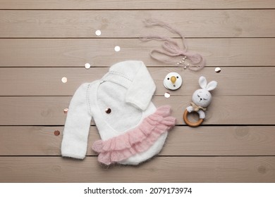 Flat Lay Composition With Cute Baby Knitwear For Photoshoot On Wooden Background