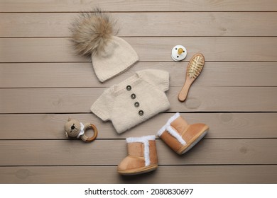 Flat Lay Composition With Cute Baby Knitwear For Photoshoot On Wooden Background