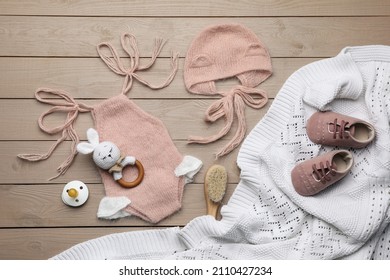 Flat Lay Composition With Cute Baby Knitwear For Photoshoot On Wooden Background