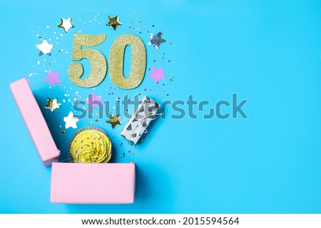 Flat lay composition with decor and numbers on light blue background, space for text. 50th birthday party