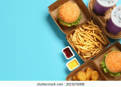 Flat Lay Composition With Delicious Fast Food Menu On Light Blue Background. Space For Text