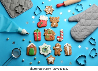 Flat lay composition with delicious gingerbread cookies and kitchen items on light blue background
