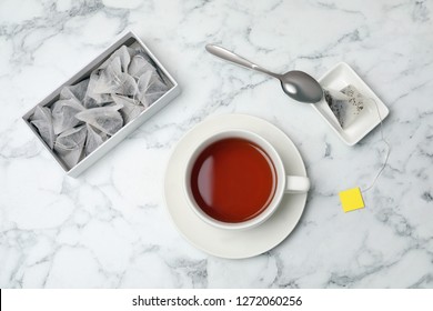 Flat lay composition with delicious hot tea on marble background