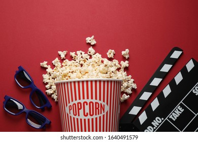 Flat lay composition with delicious popcorn on red background
